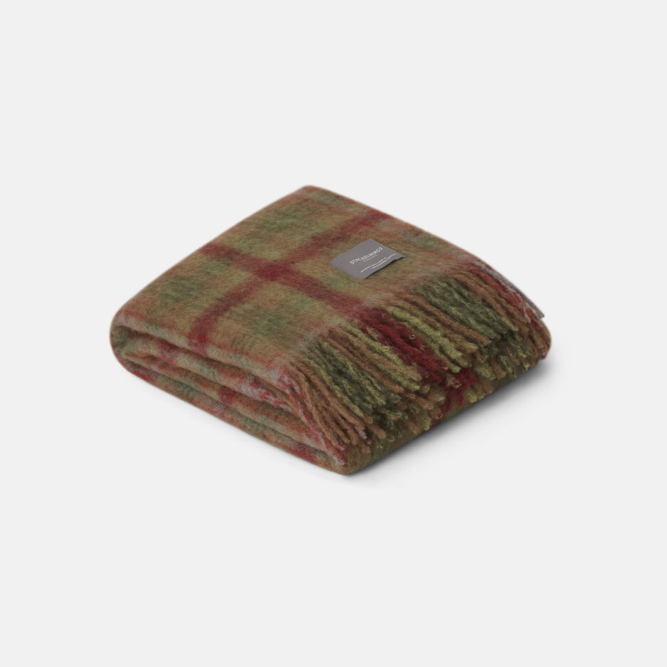 A luxurious moss & fired earth check Mohair plaid on a white backdrop.