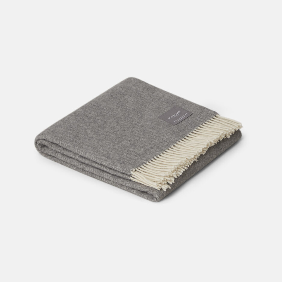 A Luxurious light grey jacquard woven plaid in recycled wool on a white backdrop.