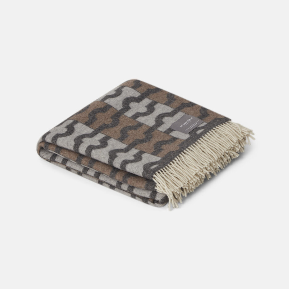 A Luxurious dark grey, brown & light grey pattern jacquard woven plaid in recycled wool on a white backdrop.