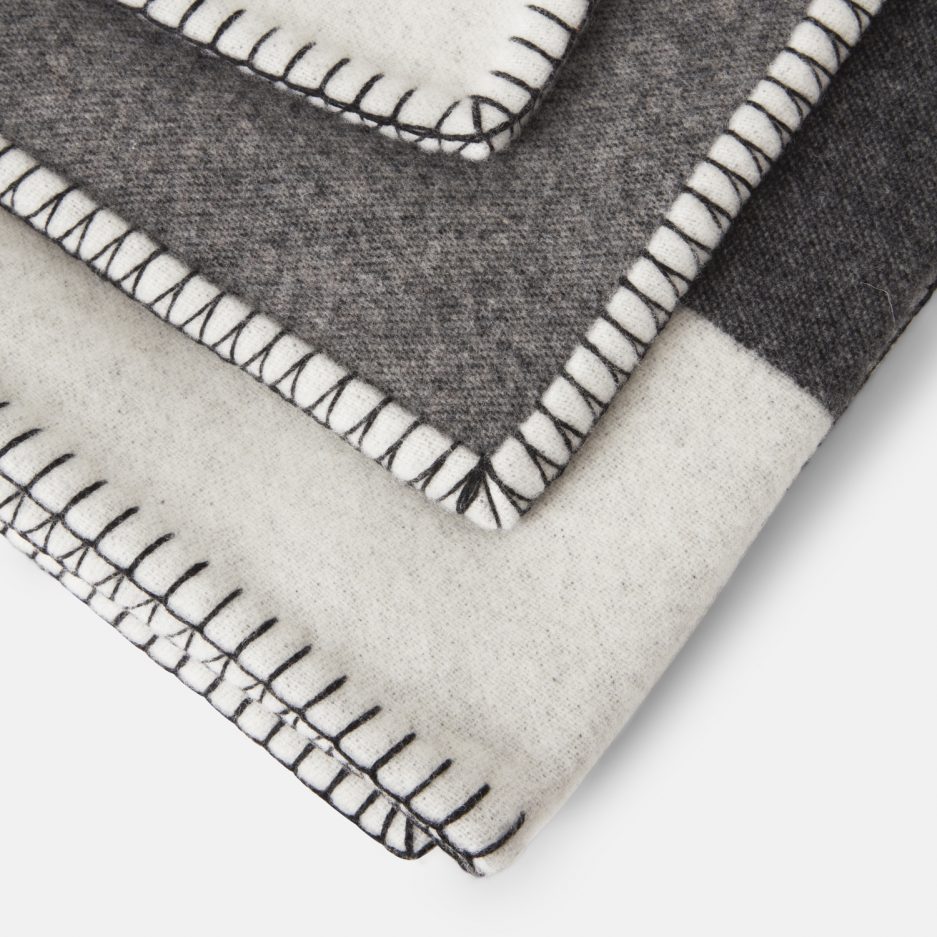 Close-up on a luxurious Antracite, Light Grey, Beige wool plaid Designed with Rosehof Art Factory on a white backdrop.