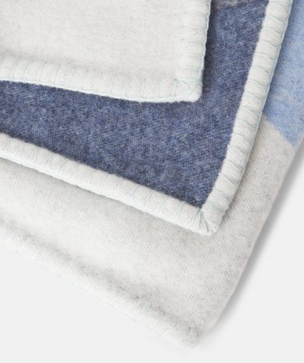 Close-up on a luxurious Light Blue, Denim, Sea Foam wool plaid Designed with Rosehof Art Factory on a white backdrop.