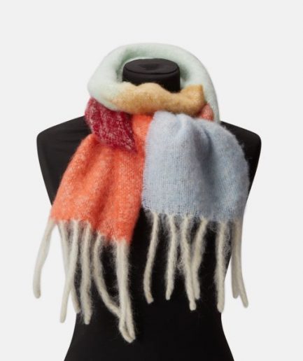 A luxurious colorful stripe scarf/ mohair plaid in orange, mint and red on a white backdrop.