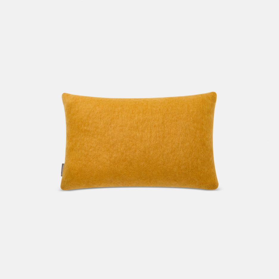 A luxurious Stackelbergs Mohair Cushion cover in Orcha on a white backdrop